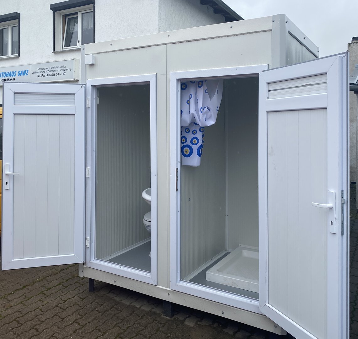 Contenedor sanitario con inodoro y ducha.